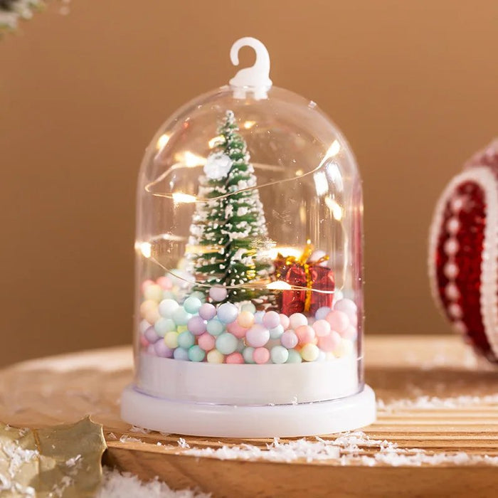 Bola de nieve con árbol de Navidad en miniatura y luces LED